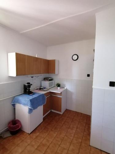 a small kitchen with a counter and a microwave at Malomtavi Vendégház in Tapolca
