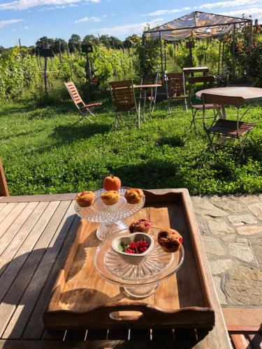 a tray with a plate of food on a table at Cascina La Maddalena Bed & Wine in Rocca Grimalda