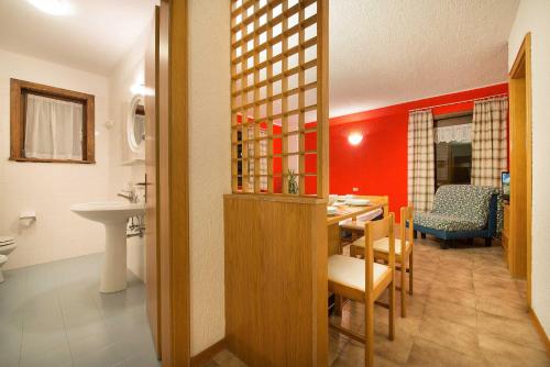 a kitchen and dining room with a table and a sink at Residence Adele in Livigno