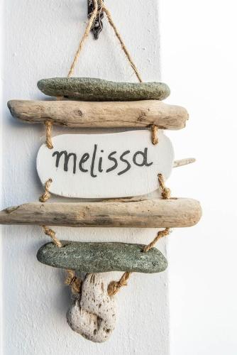 a sign with three cucumbers and a sign with missed at Avissalou Apartments in Agios Romanos