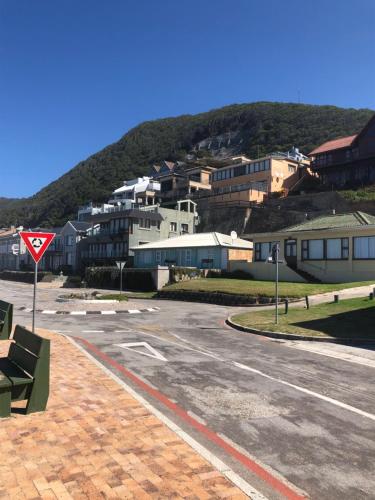 an empty street in a town with a mountain at Apartment Ozone in Herolds Bay