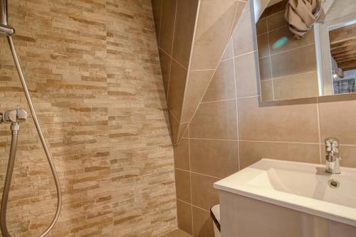 a bathroom with a sink and a shower at La Bergerie in Les Deux Alpes
