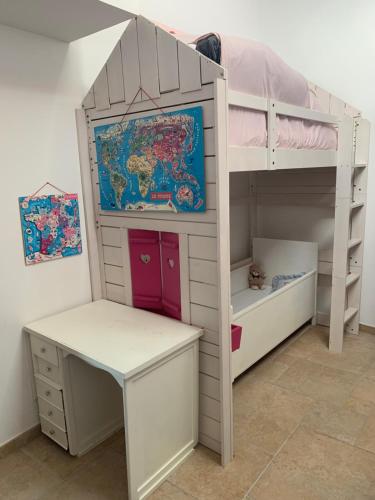 a childs bunk bed with a desk and a bunk bed with a bunk bed at VillaSarda Drome in Sauzet
