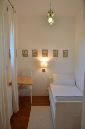a small room with two beds and a desk at Casa Vacanze Mazurine10 in Torri del Benaco