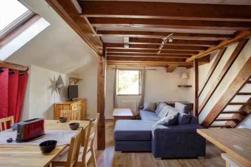 a living room with a blue couch and a table at La Bergerie in Les Deux Alpes