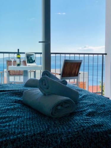 a bedroom with a blue bed with towels on it at Guest House Stipe in Brela