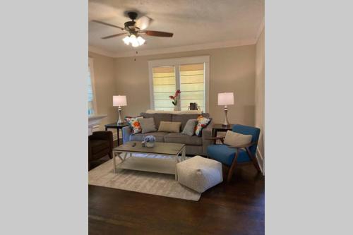 a living room with a couch and a table at Mill Cottage in Tupelo