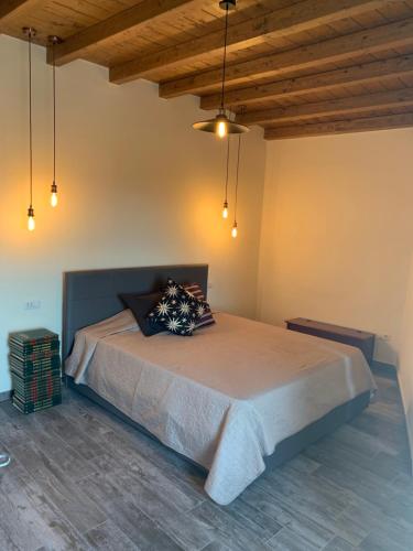 a bedroom with a large bed in a room with wooden ceilings at Vecchia Posta Casa Vacanze in Montecatini Terme