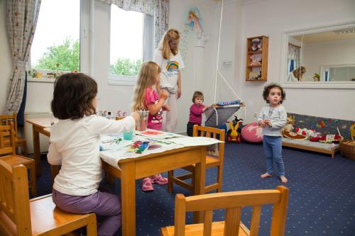 a group of children sitting at a table in a classroom at Kehida Termál Resort & Spa in Kehidakustány