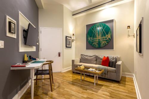 a living room with a couch and a table at Henry Norman Hotel in Brooklyn