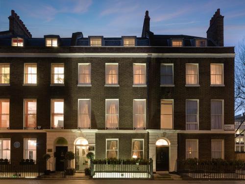 a large brick building with many windows at Staunton Hotel - B&B in London