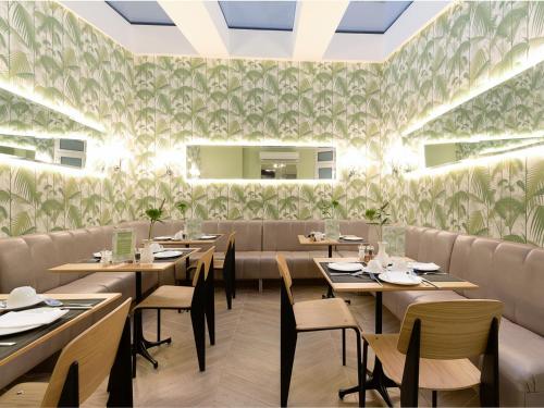 a dining room with wooden tables and chairs at Staunton Hotel - B&B in London