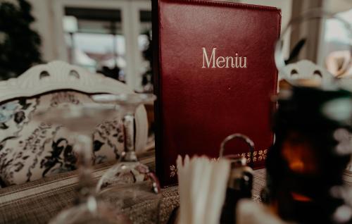 a red book with the word meiji next to a table at Juliana Platinum Brad in Brad
