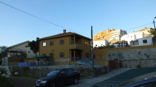 a car parked in a parking lot next to a building at Oporto Glamour Suite House in Vila Nova de Gaia