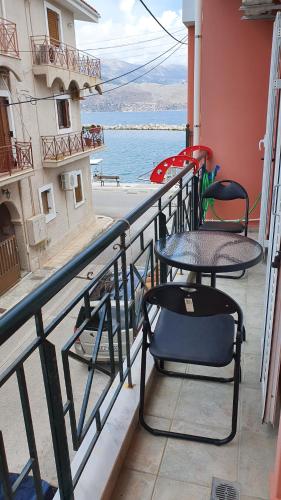 a table and chairs on a balcony with a view of the ocean at Johanna Side Sea View Apartment 2 in Lixouri