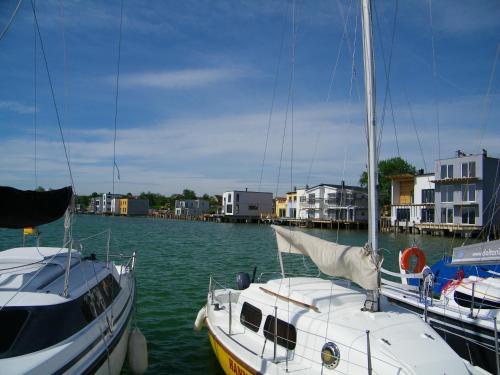 two boats are docked at a dock in the water at Laguna Seeappartements in Neukieritzsch