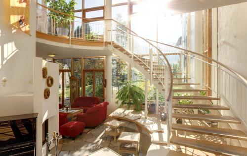 a spiral staircase in a house with a living room at Outdoorhotel Jäger Von Fall in Lenggries