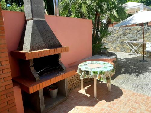 a outdoor oven with a table on a patio at Villa Very in Marina di Campo