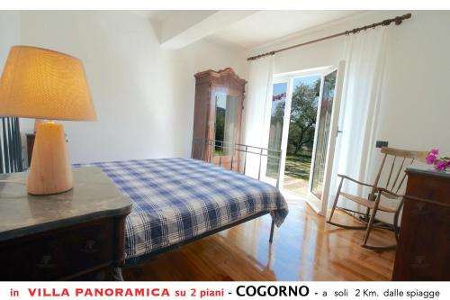 sypialnia z łóżkiem i stołem z lampką w obiekcie Appartamento A in villa con vista panoramica w mieście San Salvatore