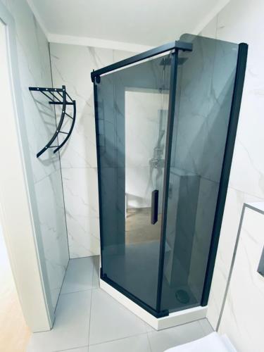 a glass shower in a bathroom with a hoop at Relax in Ostrowo