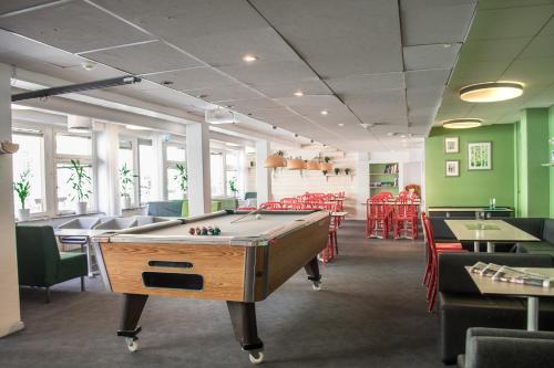a billiard room with a pool table and chairs at Backpackers Göteborg in Gothenburg