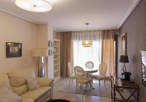 a living room with a couch and a table at Jardines de las Marinas Premium in Denia