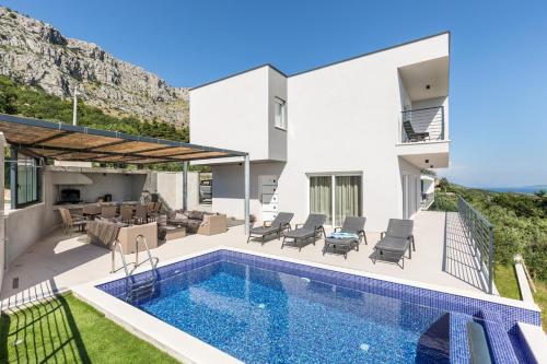 a villa with a swimming pool and a house at Villa Lipa in Jesenice