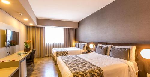 Cama ou camas em um quarto em Tauá Hotel & Convention Atibaia