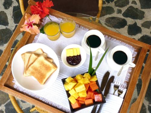 a tray of breakfast food on a table at Manala Hotel in Santa Teresa Beach