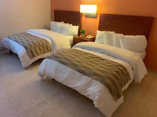 Postel nebo postele na pokoji v ubytování Casagrande Hotel
