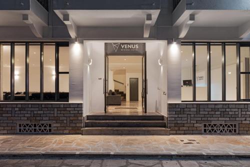 a lobby of a building with a glass door at Venus Minimal Hotel in Tinos Town