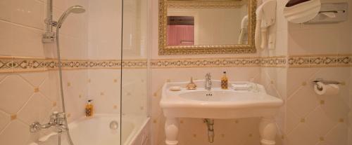 a bathroom with a sink and a shower at Hôtel Beaubourg in Paris