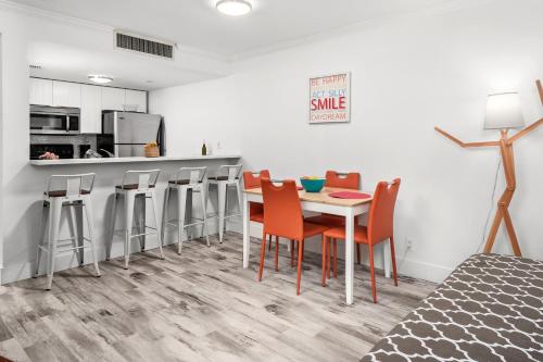 a dining room with a table and chairs at SoBe Lux Suites On Ocean in Miami Beach