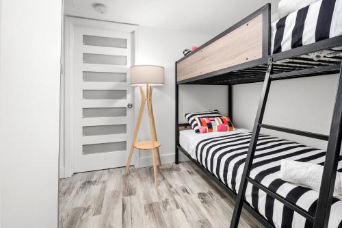 a bedroom with two bunk beds and a lamp at SoBe Lux Suites On Ocean in Miami Beach