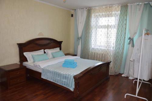 ein Schlafzimmer mit einem Bett mit blauen Handtüchern darauf in der Unterkunft Мода в доме 13 in Oral