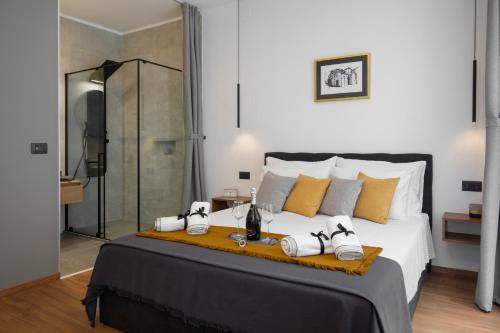 a bedroom with a large bed with shoes on it at Deluxe Rooms and Apartments Korzo in Pula