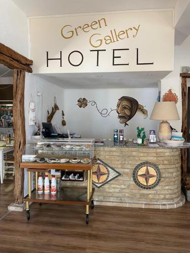 a green gallley houston sign above a store counter at Green Gallery Hotel and Restaurant in Muravera