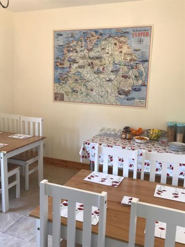 a dining room with a table and a map on the wall at Grangeview House in Grange