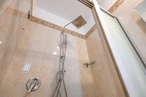 a shower with a glass door in a bathroom at Hotel Master in Brescia