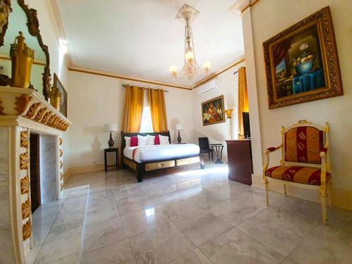 a large bedroom with a bed and a fireplace at Ocean West Boutique Hotel in Nassau