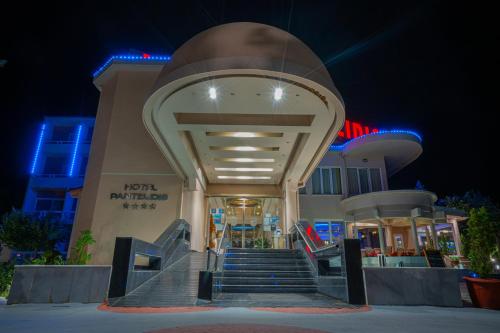 a building with stairs in front of it at night at Pantelidis Hotel & Spa in Ptolemaida