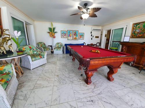 a living room with a red pool table in it at Ocean West Boutique Hotel in Nassau