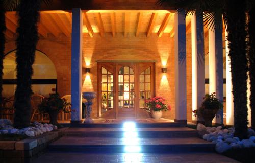 a lobby of a building with a door and palm trees at Villa Cavour in Bottanuco