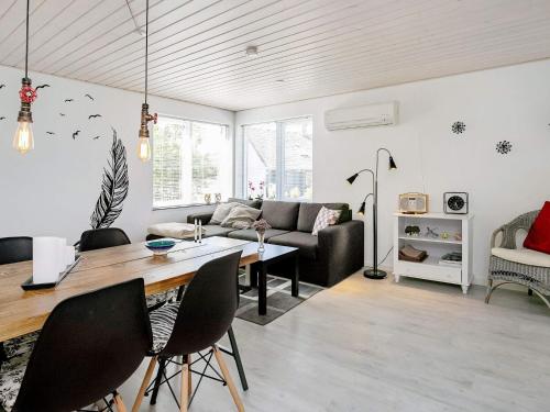 a living room with a table and a couch at 5 person holiday home in L s in Læsø