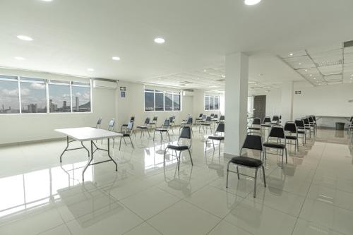 a room with tables and chairs in a building at Hotel Plaza del Arco Express in Monterrey
