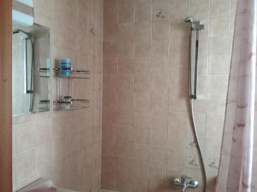 a bathroom with a shower with a shower curtain at Ático vacacional in Muros