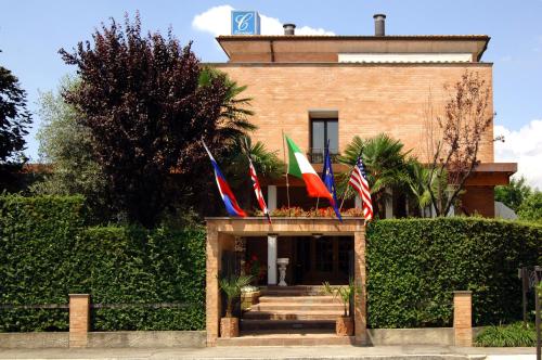 a building with flags in front of it at Villa Cavour in Bottanuco