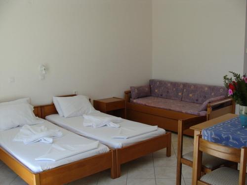 a living room with two beds and a couch at Alexandra in Marathokampos