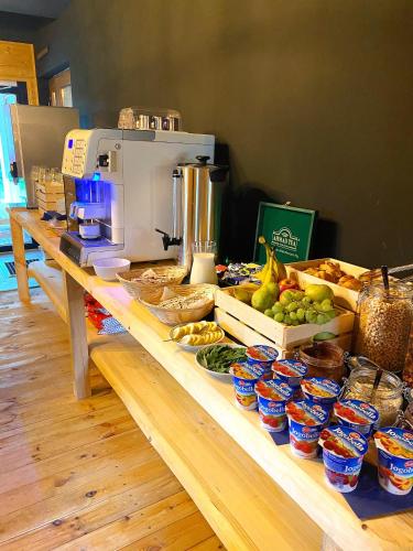 a counter with a coffee maker and food on it at Amber Blue Wellness & SPA in Karwia