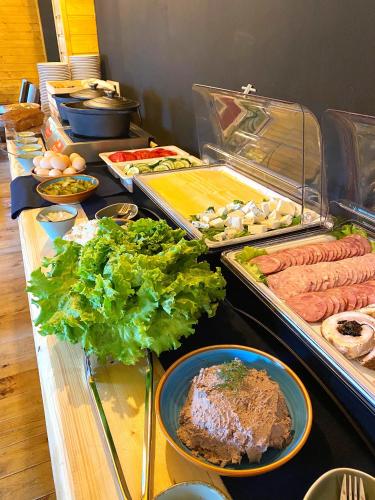a buffet line with many different types of food at Amber Blue Wellness & SPA in Karwia